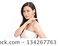 A beautiful young Asian woman with clean, fresh skin against a white background. Skincare, facial treatment, cosmetology, beauty, and spa. An elegant portrait of an Asian woman. 134267763