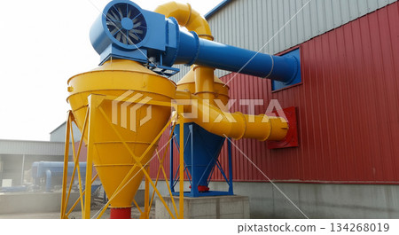 A dust collection system shows a vent flap at the bottom of the cyclone unit briefly opening. Fine dust escapes, indicating air flow during collection process at a workspace. A dust collection system shows a vent flap at the bottom of the cyclone unit briefly opening. Fine dust escapes, indicating air flow during collection process at a workspace. 134268019