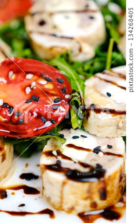 Eating Chicken caprese salad with tomato, mozzarella and balsamic dressing 134268405