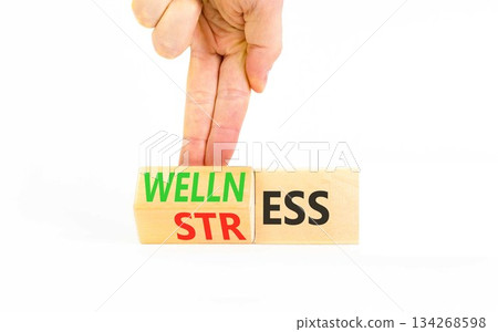 Wellness or stress symbol. Concept words Wellness or Stress on beautiful wooden cubes. Beautiful white background. Psychologist's hand. Business, psychological wellness or stress concept. Copy space. Wellness or stress symbol. Concept words Wellness or Stress on beautiful wooden cubes. Beautiful white background. Psychologist's hand. Business, psychological wellness or stress concept. Copy space. 134268598