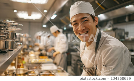 A rewarding work scene of a male chef showing off his skills in a restaurant kitchen 134268659