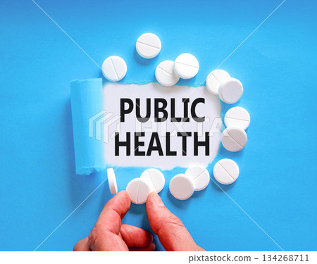 Public health symbol. Concept words Public health on beautiful white paper. White pills tablets. Doctor's hand. Beautiful blue background. Medical healthy lifestyle public health concept. 134268711