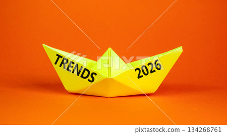 Trends 2026 new year symbol. Concept words Trends 2026 on beautiful yellow paper boat. Beautiful orange paper background. Business and Trends 2026 new year concept. Copy space. Trends 2026 new year symbol. Concept words Trends 2026 on beautiful yellow paper boat. Beautiful orange paper background. Business and Trends 2026 new year concept. Copy space. 134268761