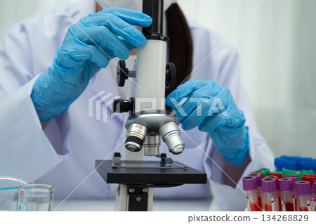 Scientist medical professional use microscope for research in science laboratory. Scientist medical professional use microscope for research in science laboratory. 134268829