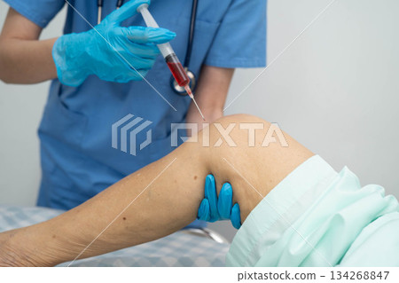 Asian doctor inject Hyaluronic acid platelet rich plasma into knee of senior woman. 134268847
