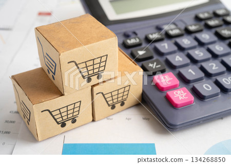 Online shopping, Shopping cart box on calculator, import export, finance commerce. Online shopping, Shopping cart box on calculator, import export, finance commerce. 134268850