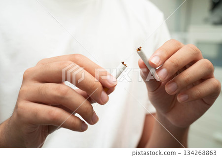Quit smoking, Asian teenage man breaking destroy cigarette in hand. Quit smoking, Asian teenage man breaking destroy cigarette in hand. 134268863