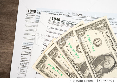 Tax form 1040 U.S. Individual Income Tax Return with dollar banknotes money. 134268894
