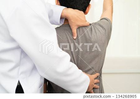 Physical therapy, Asian therapist doctor treat perform pain young man in hospital. 134268905