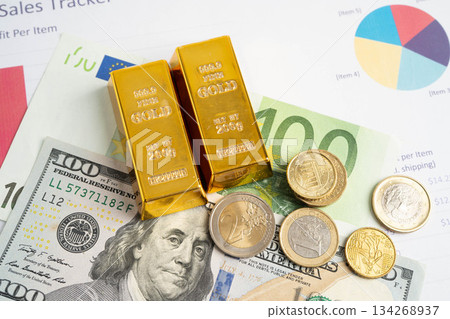 Gold bars with US dollar and Euro banknote money, finance trading investment business currency. 134268937