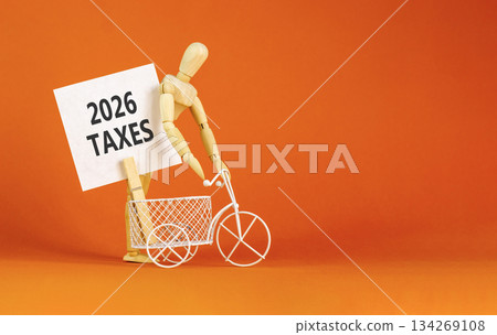 2026 taxes new year symbol. Concept words 2026 taxes on beautiful white card. Beautiful orange paper background. Businessman's model. Business and 2026 taxes new year concept. Copy space. 134269108