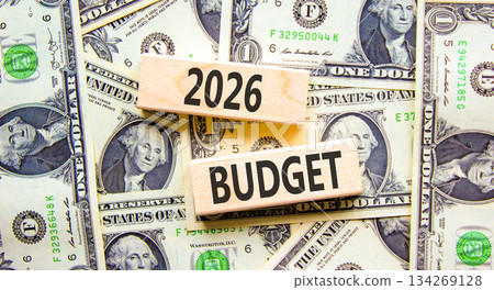 2026 Budget symbol. Concept words 2026 Budget on beautiful wooden blocks. Beautiful dollar bills background. Dollar bills. Business and 2026 budget concept. Copy space. 134269128