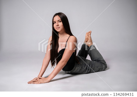 Woman yoga stretching fitness workout backbend pose flexibility healthy lifestyle studio portrait 134269431