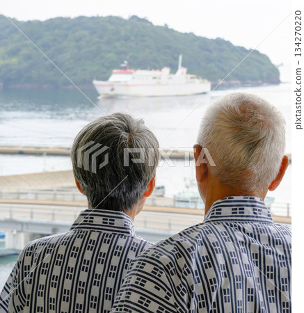 An elderly couple in traditional Japanese clothing looking out at the sea An elderly couple in traditional Japanese clothing looking out at the sea 134270220