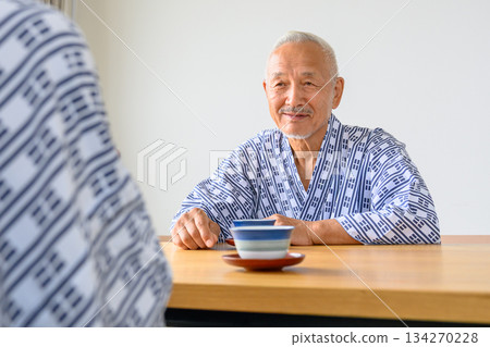 一位身穿浴衣的老者沐浴後正在品茶。 134270228