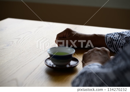 Second person perspective of a senior drinking tea Second person perspective of a senior drinking tea 134270232