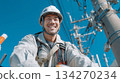A professional electrician performing electrical work on utility poles that support infrastructure. 134270234