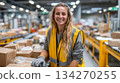 A young female employee packing boxes on the shipping line. A manufacturing and logistics professional working at a good pace. 134270255