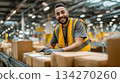 A male staff member picking products from large shelves in a logistics warehouse. Working at a site where speed and accuracy are required. 134270260
