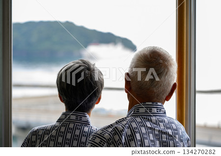 An elderly couple in yukata looking at the view from the window An elderly couple in yukata looking at the view from the window 134270282