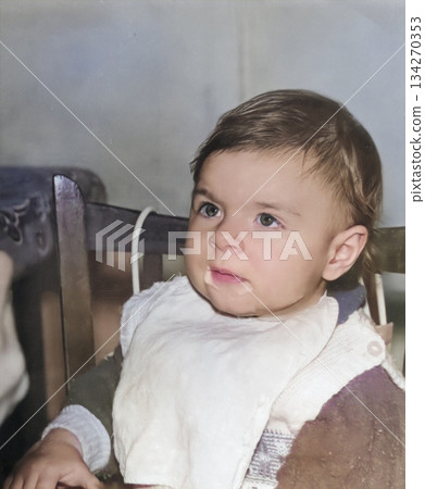 Vintage portrait of a one year old girl eating. The child's mouth is in porridge. Retro photo from 1995. Vintage portrait of a one year old girl eating. The child's mouth is in porridge. Retro photo from 1995. 134270353