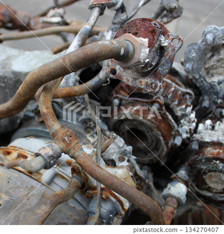 Hydraulic and oil pipes of an old engine damaged by corrosion. Dismantling of an old engine written off for disposal Hydraulic and oil pipes of an old engine damaged by corrosion. Dismantling of an old engine written off for disposal 134270407