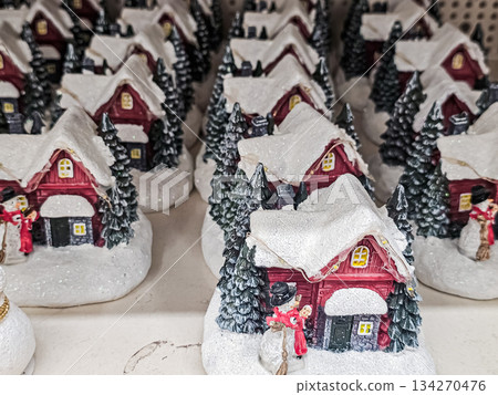 Ceramic Snow-Covered Houses with Christmas Tree on Store Shelf 134270476