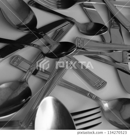 Tarnished By Time Table Knives, Tablespoons And Forks Scattered On White Table Square Stock Photo 134270523