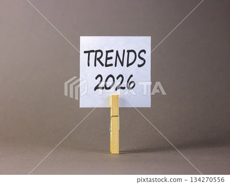 Trends 2026 new year symbol. Concept words Trends 2026 on beautiful white paper on wooden clothespin. Beautiful grey background. Business and Trends 2026 new year concept. Copy space. Trends 2026 new year symbol. Concept words Trends 2026 on beautiful white paper on wooden clothespin. Beautiful grey background. Business and Trends 2026 new year concept. Copy space. 134270556
