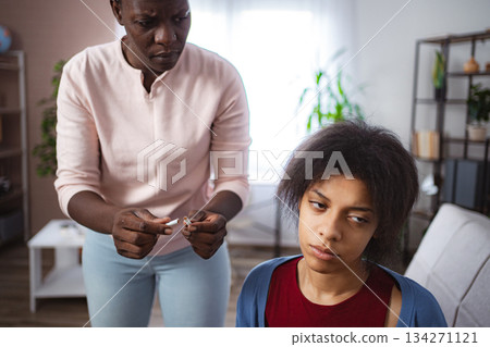 Mother scolding her teenager daughter for smoking Mother scolding her teenager daughter for smoking 134271121