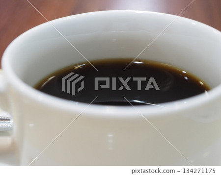 Freshly brewed black coffee poured into a white cup - an image of cafe break time Freshly brewed black coffee poured into a white cup - an image of cafe break time 134271175
