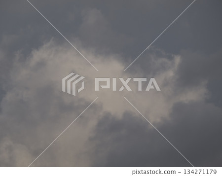Texture of a dark, heavy, cloudy sky and clouds that look like it's about to rain. A background for images of bad weather and anxiety. Texture of a dark, heavy, cloudy sky and clouds that look like it's about to rain. A background for images of bad weather and anxiety. 134271179