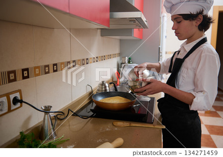 Chef Student Preparing Pancake Batter in Modern Kitchen for Class Recipe Chef Student Preparing Pancake Batter in Modern Kitchen for Class Recipe 134271459