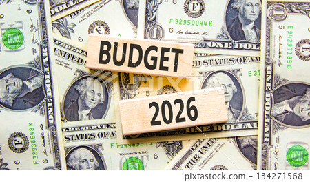 Budget 2026 symbol. Concept words Budget 2026 on beautiful wooden blocks. Beautiful dollar bills background. Dollar bills. Business and budget 2026 concept. Copy space. Budget 2026 symbol. Concept words Budget 2026 on beautiful wooden blocks. Beautiful dollar bills background. Dollar bills. Business and budget 2026 concept. Copy space. 134271568