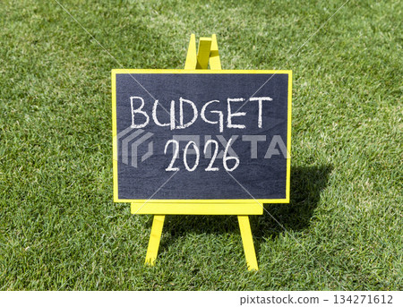 Budget 2026 symbol. Concept words Budget 2026 on beautiful black blackboard. Beautiful green grass background. Business and budget 2026 concept. Copy space. Budget 2026 symbol. Concept words Budget 2026 on beautiful black blackboard. Beautiful green grass background. Business and budget 2026 concept. Copy space. 134271612