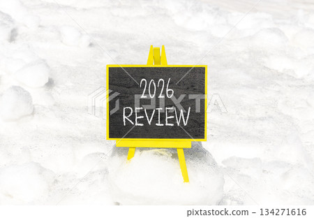 2026 Review symbol. Concept words 2026 Review on beautiful black blackboard. Beautiful white snow background. Business and 2026 review concept. Copy space. 134271616