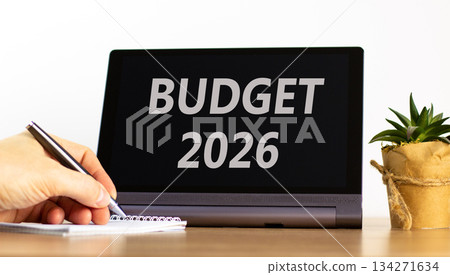 Budget 2026 symbol. Concept words Budget 2026 on beautiful black tablet screen. Beautiful white background. Businessman's hand. Business and budget 2026 concept. Copy space. 134271634