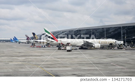 A lineup of global airlines including Emirates, Singapore Airlines, and Qatar Airways showcases international aviation activity A lineup of global airlines including Emirates, Singapore Airlines, and Qatar Airways showcases international aviation activity 134271703