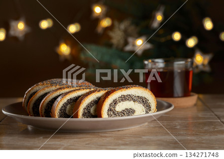 Poppy seed roll pieces on a background of Christmas tree. Poppy seed roll pieces on a background of Christmas tree. 134271748
