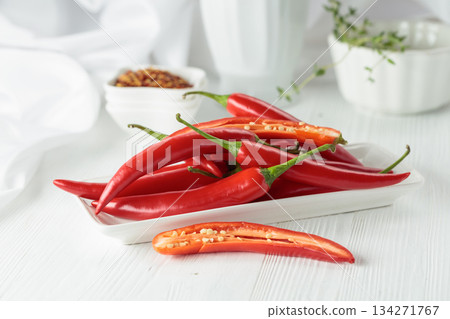 Fresh red chili peppers with on a white wooden table. Fresh red chili peppers with on a white wooden table. 134271767