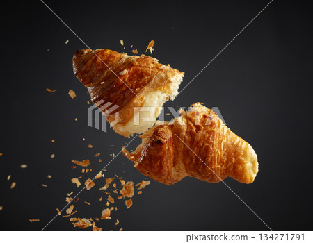 Croissant in air on a black background. 134271791