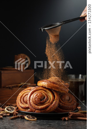 Kanelbullar. Freshly baked buns sprinkled with cinnamon. 134271800