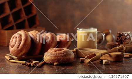 Swedish cinnamon rolls and coffee latte on a brown background. 134271807