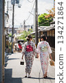 Two women in yukata holding hands in Higashiyama with a rickshaw in the background. Kyoto City, Kyoto Prefecture, Japan 134271864