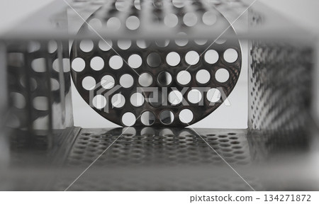 Metal plates of different shapes with round holes of different diameters abstract background Metal plates of different shapes with round holes of different diameters abstract background 134271872