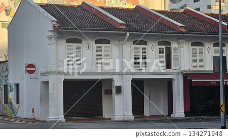 A colonial-style shophouse with shuttered windows  134271948
