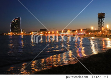 Night view of the coastline and the Balearic Sea (Mediterranean Sea) from the sandy beach of Sant Miquel Beach in Barcelona 134271951