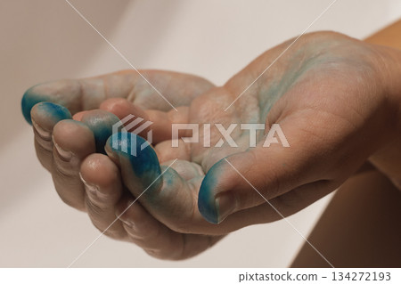 Child's hand covered in bright, vibrant paint, a sign of messy but happy creativity Child's hand covered in bright, vibrant paint, a sign of messy but happy creativity 134272193