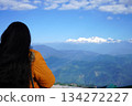 Young woman looking at snowcapped Himalayan mountain peaks from a scenic viewpoint at Darjeeling 134272227