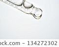 Cosmetic pipette dropping translucent serum with bubbles 134272302